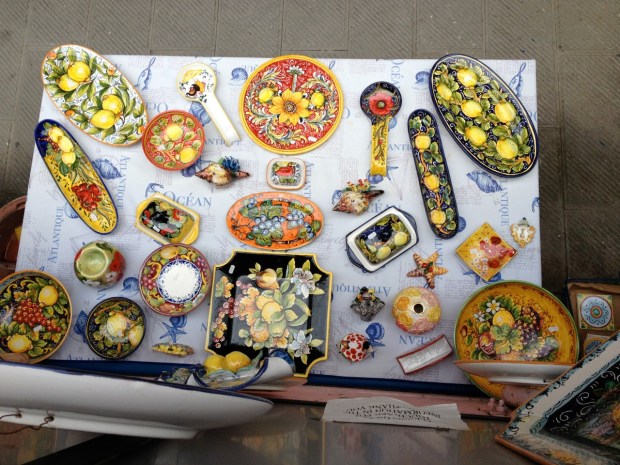 I would love to have brought back an entire kitchen full of dishes. I settled for a wine stopper, salad spoons and a cheese board of olive wood, and a small blue plate in the shape of a fish which now sits by my stove to hold spoons.